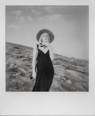 White polaroid photo frame with black and white photo of Fallon Stovall in a dress and hat