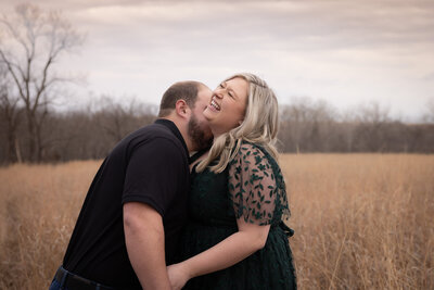 man and woman laughing with sun peeking through