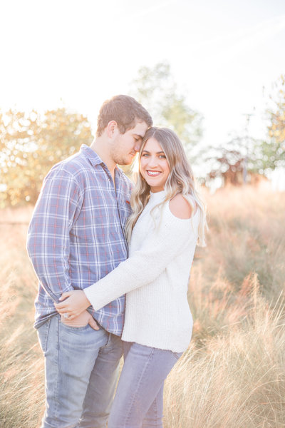engaged couple in tall grass