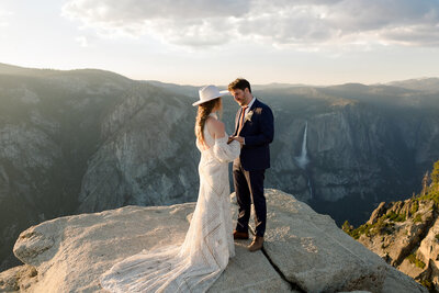 A bride and groom walk through Tuolumne Meadows in Yosemite National Park. 