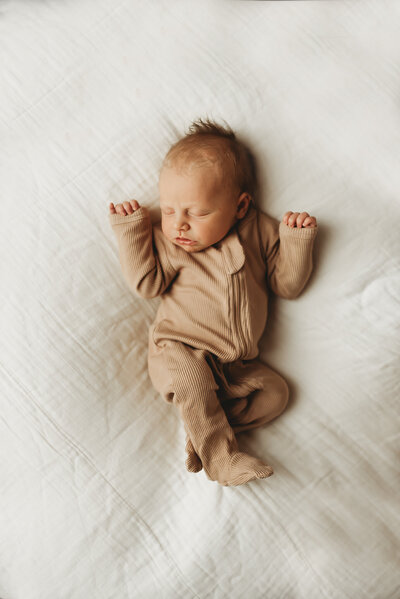 A little one sleeps soundly during a studio newborn session with Nikii Pix Photography in Bismarck, ND