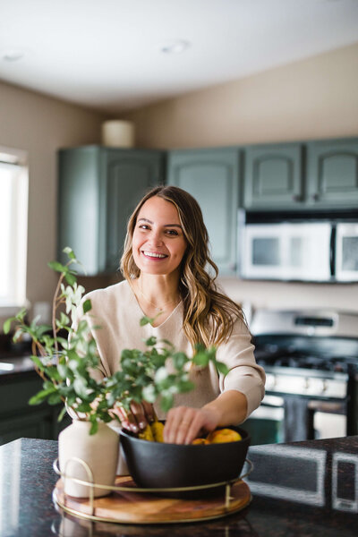 woman styling her kitchen decor