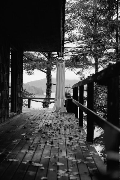a wedding dress hanging from a porch in Maine