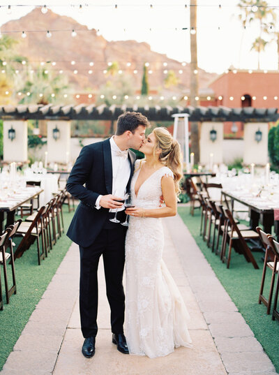 Bride and groom kissing at reception at Omni Montelucia Wedding