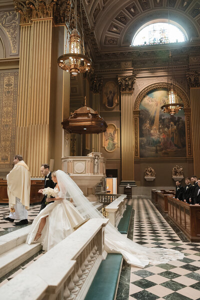 Bride and groom walking up the alter at Cathedral Basilica of Saint Peter and Paul wedding ceremony in Philadelphia