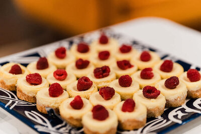 bite sized cheesecakes with raspberry on top