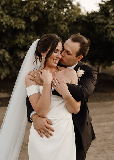 bride and groom hugging on wedding day