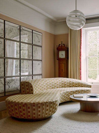 Hanging chair in living above cream rug