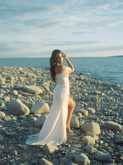 A bride poses on a beach