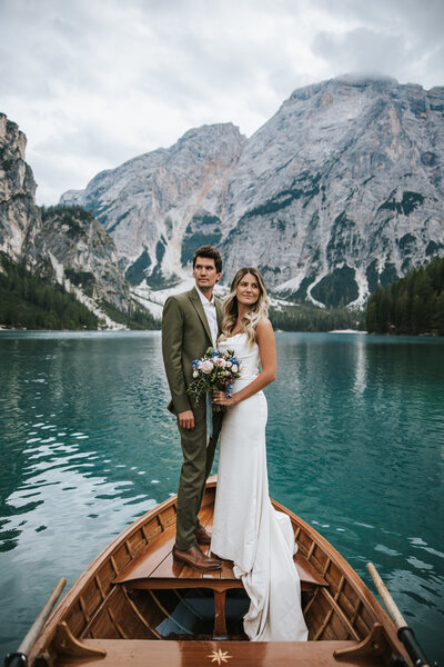 Bride and groom celebrate their love on their wedding day against the backdrop of the Dolomites.