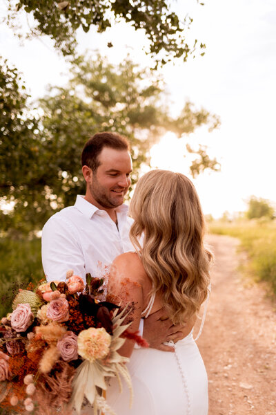 couple holding each other on path