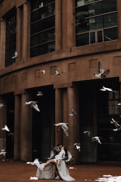 Couple dip and kiss as geese fly over them