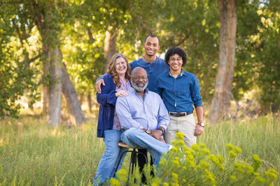 family of four standing together in a field