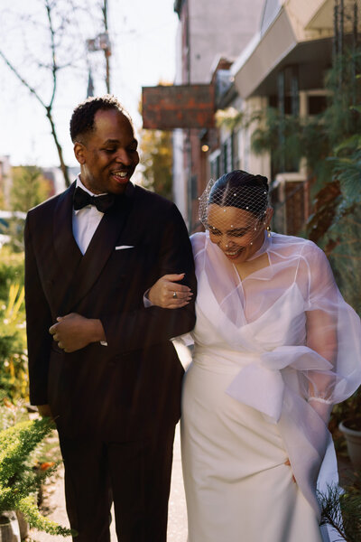 Couple walking down the street at their city wedding