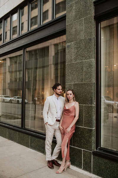 a moody couple posing downtown engagement photo