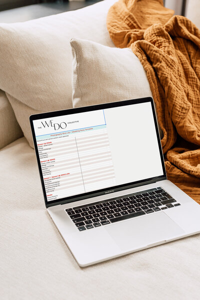 Mockup image of a laptop on a couch with an orange blanket in the background. On the laptop screen, is the photography shot list spreadsheet