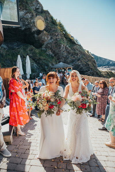 brides celebrating the end of wedding ceremony