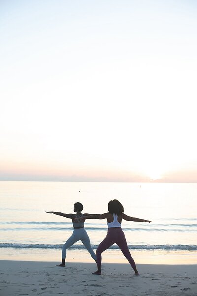 Woman doing yoga on a beach