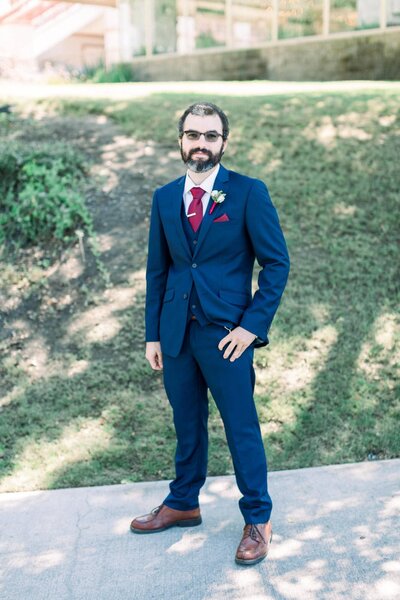 Three16 Photography Photo Booth Attendant Bryan poses in a sharp looking suit at a wedding