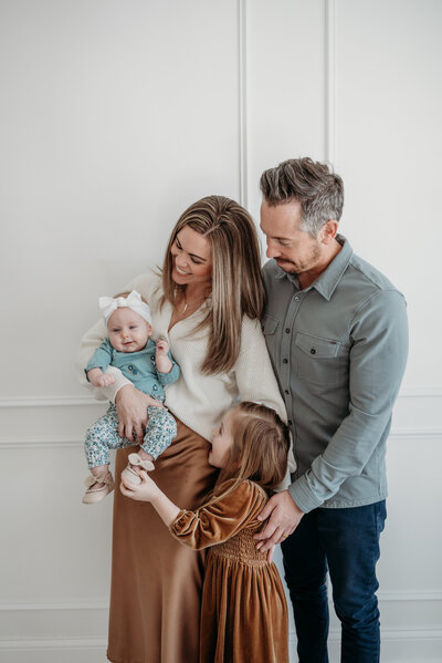 Candid photo of a family with two girls during a studio family photo session in Bartlett, IL