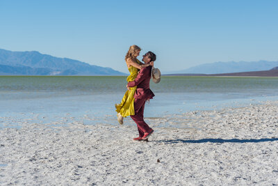 A person holding their partner up and smiling