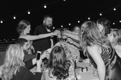 High-energy shot of the couple dancing with guests at their lively Quirk Hotel wedding reception.