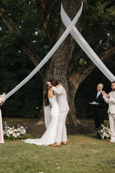 Bride standing on a bridge having wedding portraits done