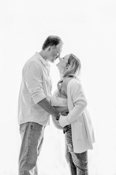 black and white back lit studio portrait of husband and wife together at a maternity session