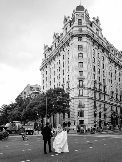 Bride and groom walk across the street towards the DC Willard Intercontinental 