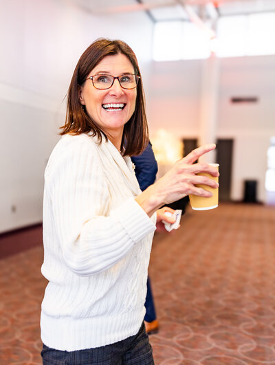 a woman smiling at an event