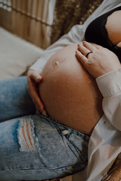 Pregnant parent holding their belly 