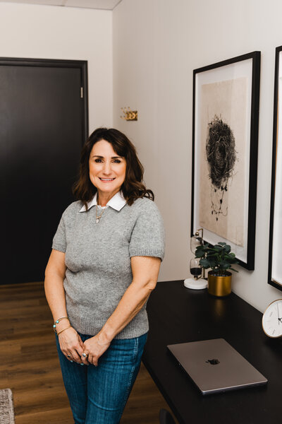 Dena standing in the entryway of her office