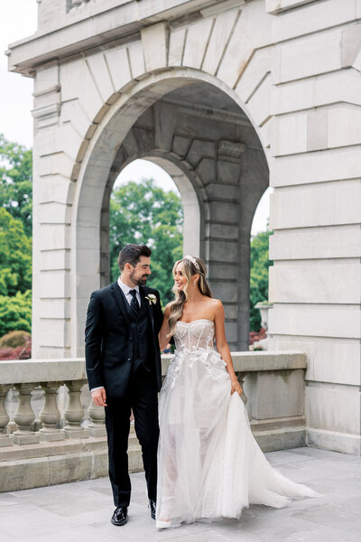 Husband and wife enjoying each other's company during their wedding at Castle at Skylands Manor Wedding