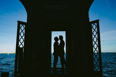 Two Grooms Hugging in a Silhouette Portrait at Vizcaya in Miami