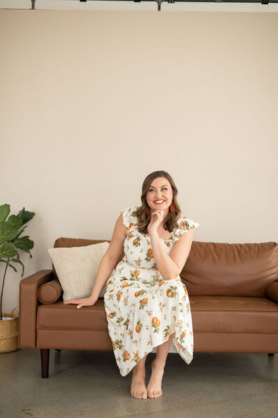 Allea Grummert is the owner of Duett and writes email content for bloggers, sitting on a couch