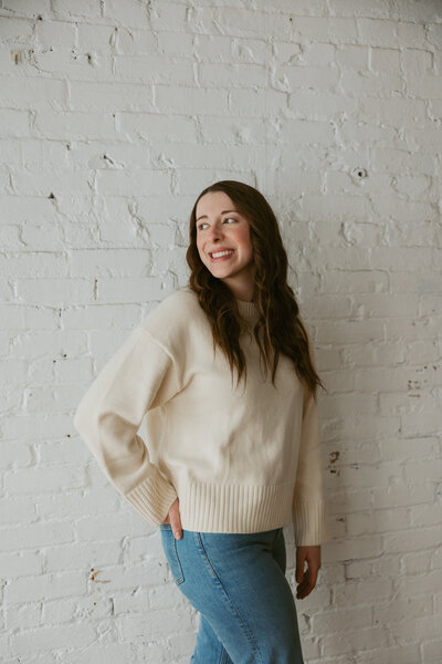 portrait photo of girl with brown hair in a cream crew neck | Event Planner| Magnolia Tree Weddings| Wedding event planner 