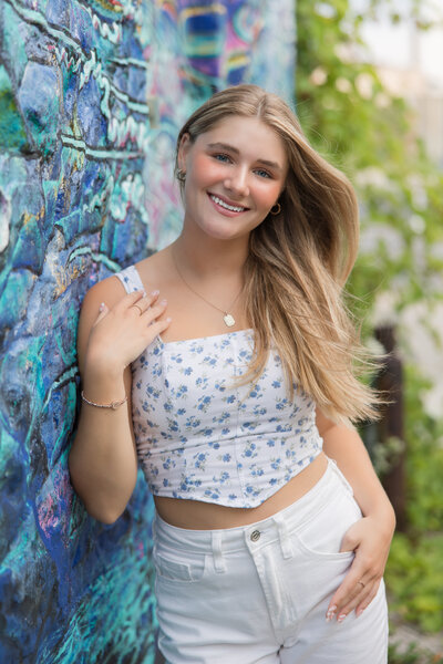 Senior girl standing on the beach and smiling