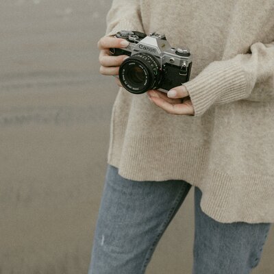 Close up of photographer holding film camera