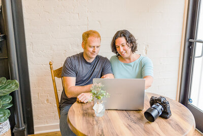 Kevin and Renee sitting at laptop with camera on table