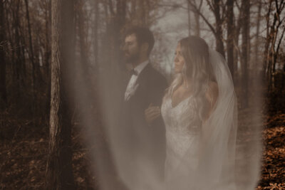 girl leading boy through maze garden engagement photo