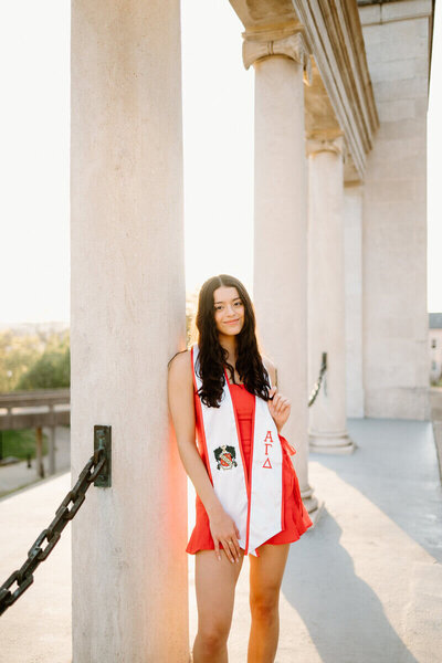 senior wearing red and posing for nashville senior photographer