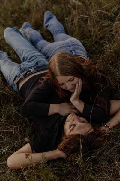 Cute Photo of a couple laying in the grass wearing matching outfits in Southern Wisconsin