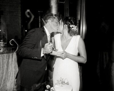 bride and groom kissing at cake cutting at ladybird johnson wildflower center in austin texas