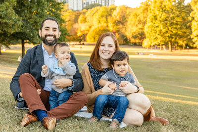 family sitting in Piedmont park during photo session with laure photography