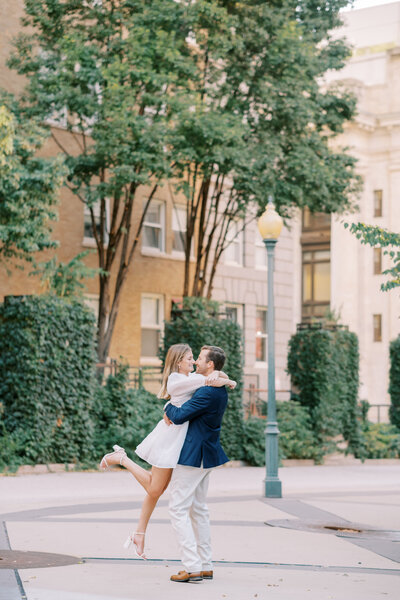 couple sitting on steps of classic architecture building during engagement session