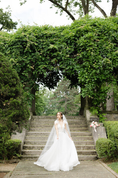 bride walking through a garden