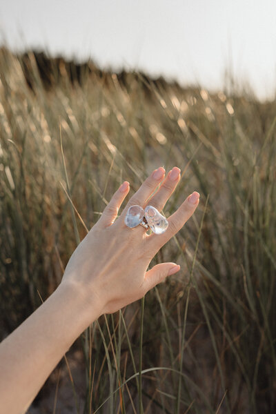 Woman’s hand wearing crystal rings during mindfulness and energy healing