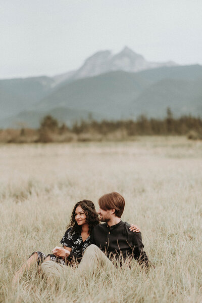 couple sitting in front of mountain