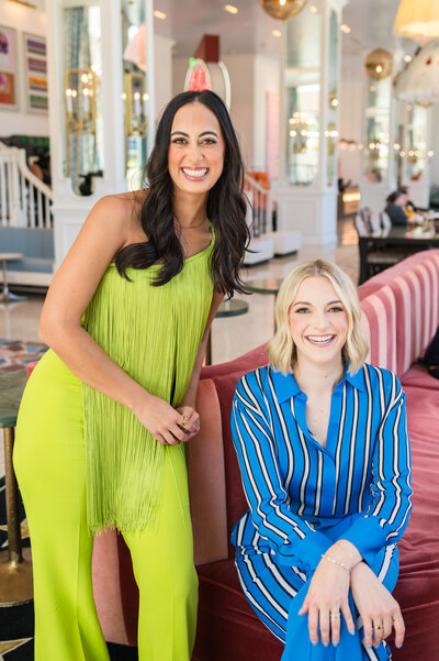 Dr. Brooks and Dr. Templeton, orthodontists in Nashville, TN smiling together in bright colored outfits