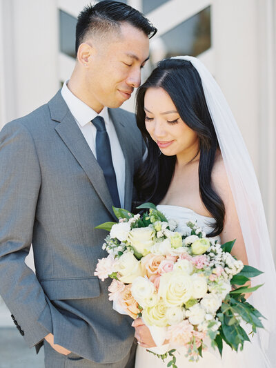An intimate ceremony and elopement at their home church with their closes family members. A couple hand in hand embracing the intimate moments of their marriage.